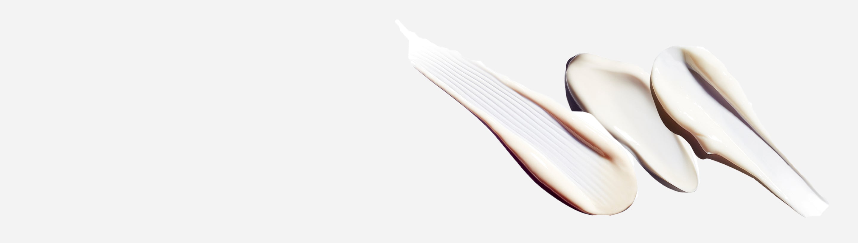 Creams smeared on a white background.